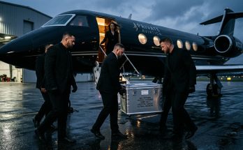 Royal security staff loading a medical cooler containing King Charles's personal blood supply onto a private jet for an international tour.